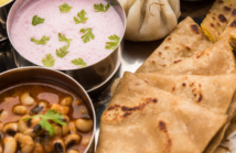 Maharashtrian food Thali or platter - Mumbai style Meal from Indian State Maharashtra includes, roti, rice, dal, sabji, sweet roti and rice, kadhi, Modak, papad etc