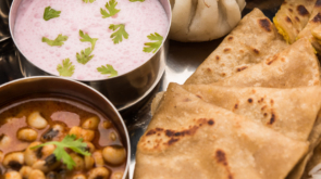 Maharashtrian food Thali or platter - Mumbai style Meal from Indian State Maharashtra includes, roti, rice, dal, sabji, sweet roti and rice, kadhi, Modak, papad etc